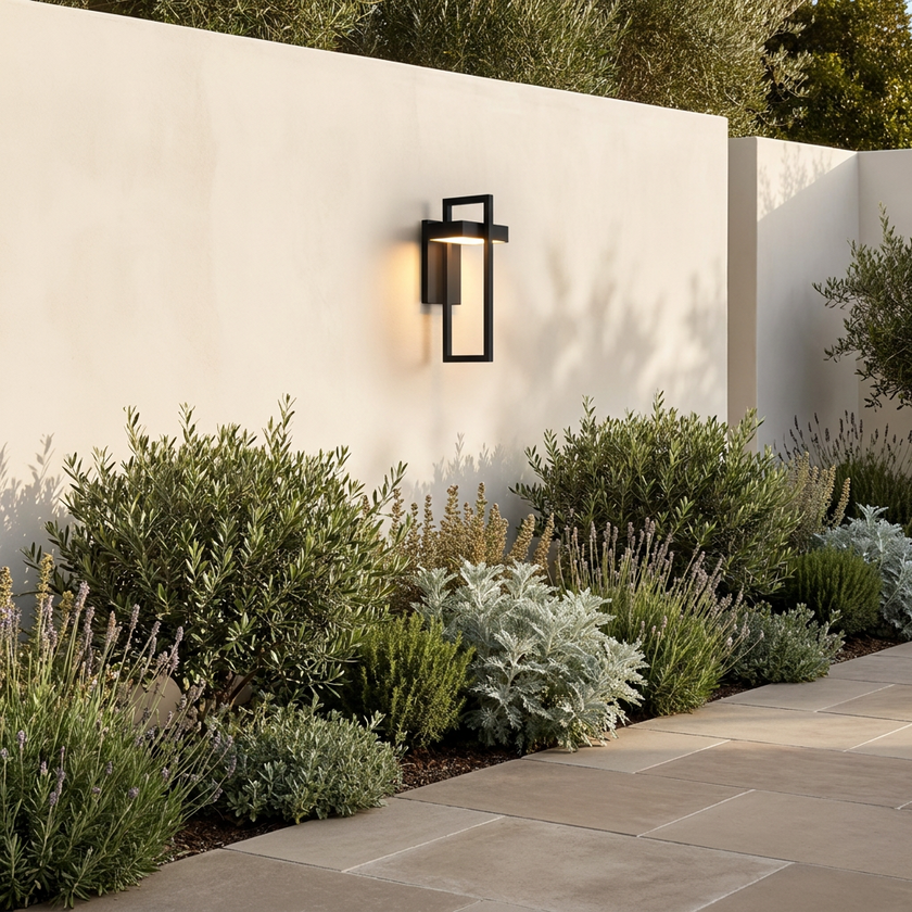 Terri sconce on a garden wall above planting